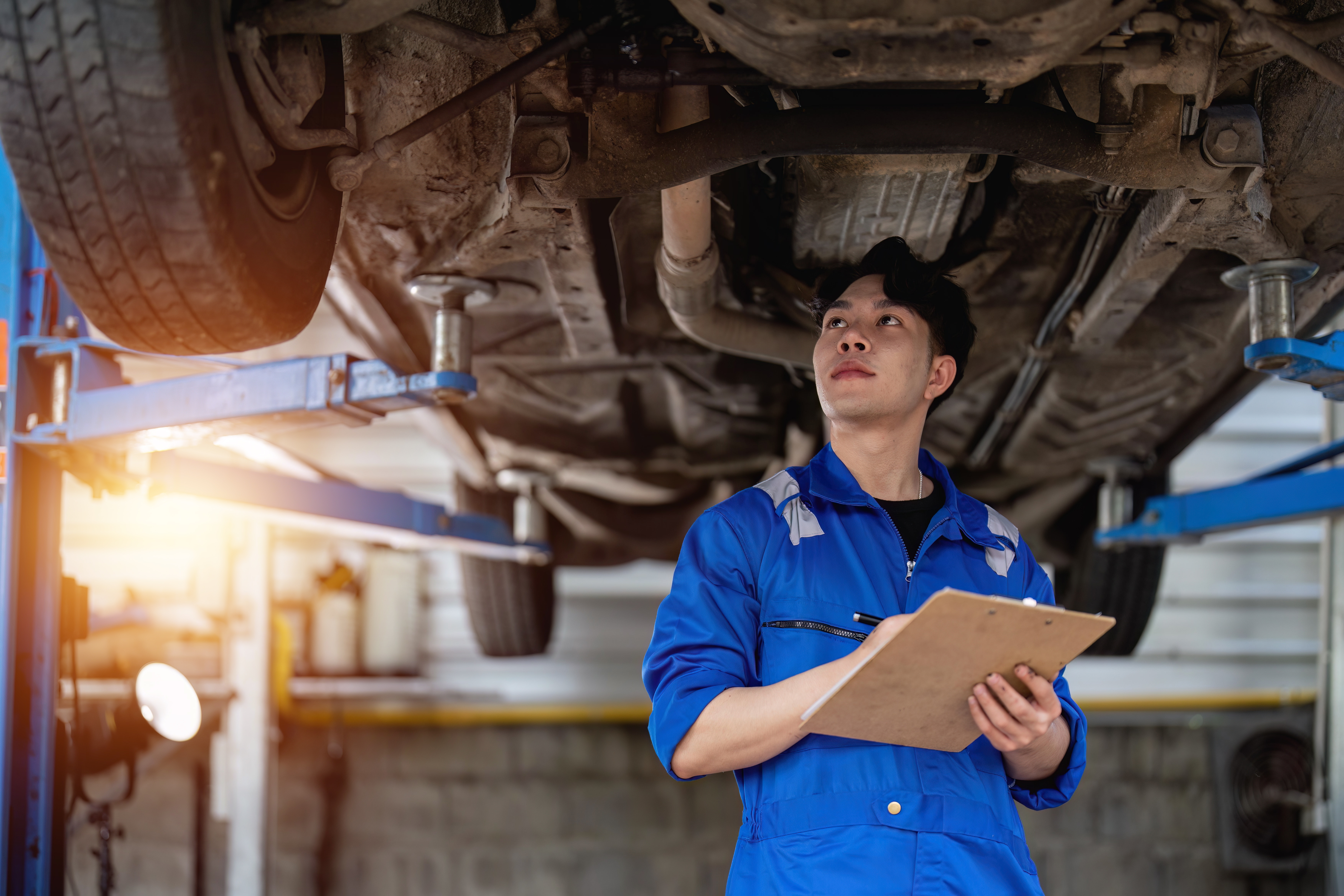Professional mechanic inspecting car